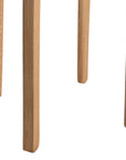 A sleek natural oak round stool featuring a minimalist design with subtly curved legs. Crafted from solid oak with a clear finish, this versatile piece functions as a stool or side table, adding a modern touch to any space