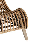 A sculptural natural rattan lounge chair with a curved, low-profile silhouette and sleek wooden legs. The woven design adds texture, while the deep seat and ergonomic shape offer comfort and relaxation.