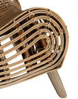A sculptural natural rattan lounge chair with a curved, low-profile silhouette and sleek wooden legs. The woven design adds texture, while the deep seat and ergonomic shape offer comfort and relaxation