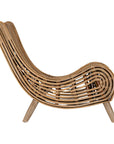 A sculptural natural rattan lounge chair with a curved, low-profile silhouette and sleek wooden legs. The woven design adds texture, while the deep seat and ergonomic shape offer comfort and relaxation