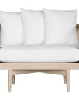 Natural rope lounge chair with white cushions, featuring a light timber frame and modern coastal aesthetic.