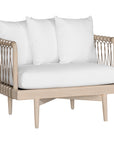 Natural rope lounge chair with white cushions, featuring a light timber frame and modern coastal aesthetic.