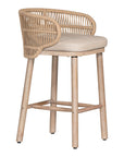 Handwoven rope counter stool with a curved backrest, cushioned seat, and sturdy wooden legs, perfect for relaxed coastal and modern interiors