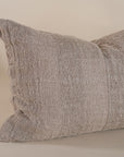 Natural linen cushion with a textured finish in a soft, neutral tone, perfect for adding warmth and comfort to any living space.