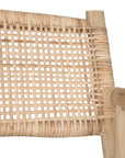 Natural rattan armchair with rustic branch frame, perfect for adding a touch of organic texture to any dining space