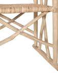 Natural rattan armchair with rustic branch frame, perfect for adding a touch of organic texture to any dining space