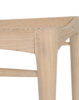 Natural timber dining chair with woven cane seat and curved backrest, ideal for relaxed, coastal-inspired dining spaces