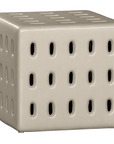 Niche side table in sand finish with perforated detailing creating a sculptural form with soft tonal warmth.