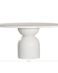 Nuru dining table in eggshell finish with round stone top and sculptural pedestal base isolated on a light background