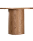 Contemporary oak dining table featuring a sleek rounded design with a solid cylindrical base, perfect for modern interiors