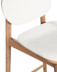 A contemporary bar stool featuring a natural oak frame with a curved white upholstered seat and backrest, designed for modern kitchens and dining spaces