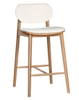 A contemporary bar stool featuring a natural oak frame with a curved white upholstered seat and backrest, designed for modern kitchens and dining spaces