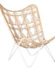 A handcrafted butterfly chair featuring an intricately woven natural rattan seat with a geometric pattern, supported by a sleek white metal frame