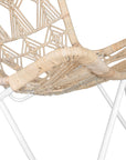 A handcrafted butterfly chair featuring an intricately woven natural rattan seat with a geometric pattern, supported by a sleek white metal frame