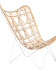 A handcrafted butterfly chair featuring an intricately woven natural rattan seat with a geometric pattern, supported by a sleek white metal frame