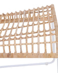 A handwoven rattan dining chair with a white metal frame, featuring an airy, open-weave design. The natural rattan seat and backrest bring an organic touch to contemporary and coastal interiors