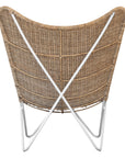 A stylish rattan sling chair with a white metal frame, featuring an airy woven seat and a relaxed silhouette, perfect for modern coastal and bohemian interiors.