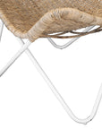 A stylish rattan sling chair with a white metal frame, featuring an airy woven seat and a relaxed silhouette, perfect for modern coastal and bohemian interiors.