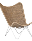 A stylish rattan sling chair with a white metal frame, featuring an airy woven seat and a relaxed silhouette, perfect for modern coastal and bohemian interiors.