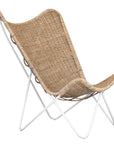 A stylish rattan sling chair with a white metal frame, featuring an airy woven seat and a relaxed silhouette, perfect for modern coastal and bohemian interiors.