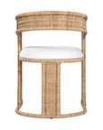 A natural rattan dining chair with a curved backrest and a white upholstered cushion. The woven design and sturdy frame create a stylish and comfortable seating option, perfect for modern coastal or relaxed interiors