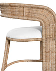 A natural rattan dining chair with a curved backrest and a white upholstered cushion. The woven design and sturdy frame create a stylish and comfortable seating option, perfect for modern coastal or relaxed interiors