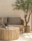 A beautifully styled living space featuring a natural rope weave lounge set with plush grey cushions, complemented by a rustic wooden coffee table and textured decor. Perfect for indoor or covered outdoor relaxation with a contemporary coastal aesthetic.