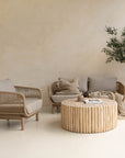 A beautifully styled living space featuring a natural rope weave lounge set with plush grey cushions, complemented by a rustic wooden coffee table and textured decor. Perfect for indoor or covered outdoor relaxation with a contemporary coastal aesthetic.