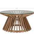 A stylish round dining table featuring a sculptural wooden base with a clear glass top, offering a contemporary yet natural aesthetic for modern dining spaces.