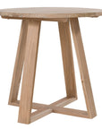 Round teak cafe table with a natural finish and angled legs, perfect for relaxed modern interiors