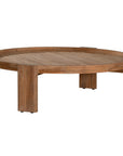 The Kulala Living Round Teak Coffee Table, crafted from solid teak with a slatted tabletop and sturdy block legs. This timeless design adds warmth and natural texture to any living space
