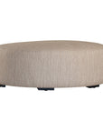 Curved upholstered ottoman with natural textured fabric and subtle black feet, ideal for contemporary living spaces
