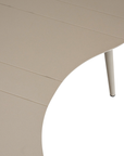 Solara coffee table with organic curved shape and light finish on a clean studio background.