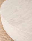 Tabati coffee table in eggshell hydro dipped finish with rounded low profile form styled in a soft neutral living room.