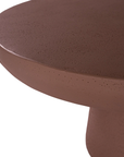 Tarran coffee table in cinnabar clay finish with rounded top and sculptural cylindrical leg