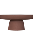 Tarran coffee table in cinnabar clay finish with rounded top and sculptural cylindrical leg