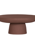 Tarran coffee table in cinnabar clay finish with rounded top and sculptural cylindrical leg