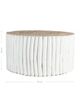 A round coffee table crafted from natural teak branches, arranged in a drum-style design. The organic texture and neutral tones make it a statement piece for coastal and contemporary interiors