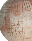 Terracotta table lamp featuring a textured spherical base with intricate grid detailing and a wide conical fabric shade in a neutral tone
