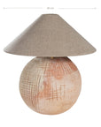 Terracotta table lamp featuring a textured spherical base with intricate grid detailing and a wide conical fabric shade in a neutral tone