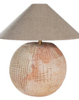 Terracotta table lamp featuring a textured spherical base with intricate grid detailing and a wide conical fabric shade in a neutral tone