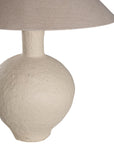 Kulala Living textured paper mache table lamp with a sculptural base and a natural linen shade. A refined lighting piece that adds warmth and organic elegance to any interior setting