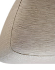 Curved upholstered ottoman with natural textured fabric and subtle black feet, ideal for contemporary living spaces