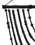 Black wooden beaded wall hanging with layered strands, creating a bold decorative statement for modern interiors