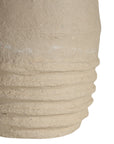 Sculptural table lamp with a cream textured paper mace base and neutral linen shade, adding organic elegance to any space