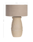 Sculptural table lamp with a cream textured paper mace base and neutral linen shade, adding organic elegance to any space