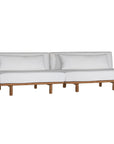 A contemporary armless sofa with plush white cushions and a sturdy natural teak wood frame. This minimalist lounge piece offers versatile seating, perfect for modern living spaces or outdoor settings