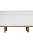 A contemporary armless sofa with plush white cushions and a sturdy natural teak wood frame. This minimalist lounge piece offers versatile seating, perfect for modern living spaces or outdoor settings