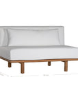 A contemporary armless sofa with plush white cushions and a sturdy natural teak wood frame. This minimalist lounge piece offers versatile seating, perfect for modern living spaces or outdoor settings
