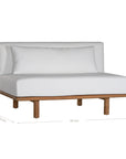 A contemporary armless sofa with plush white cushions and a sturdy natural teak wood frame. This minimalist lounge piece offers versatile seating, perfect for modern living spaces or outdoor settings